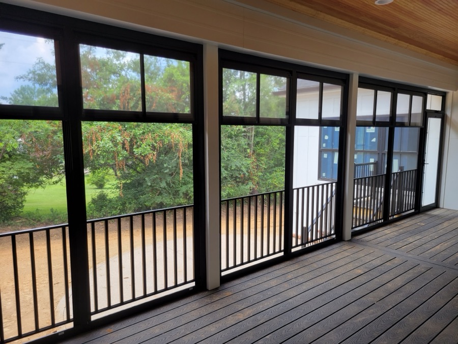Screened porch with Eze-Breeze panels overlooking a wooded yard